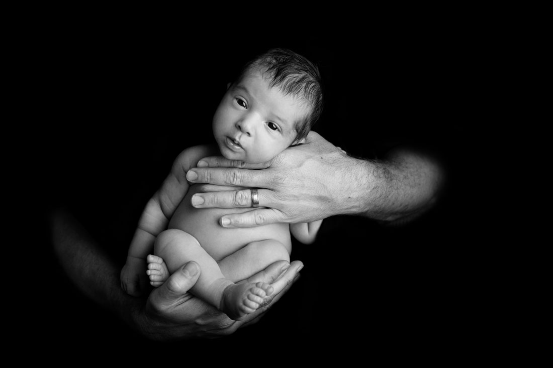 newborn in dads hands