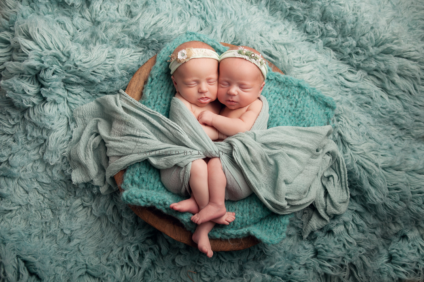 identical twins wrapped together and asleep for photo session